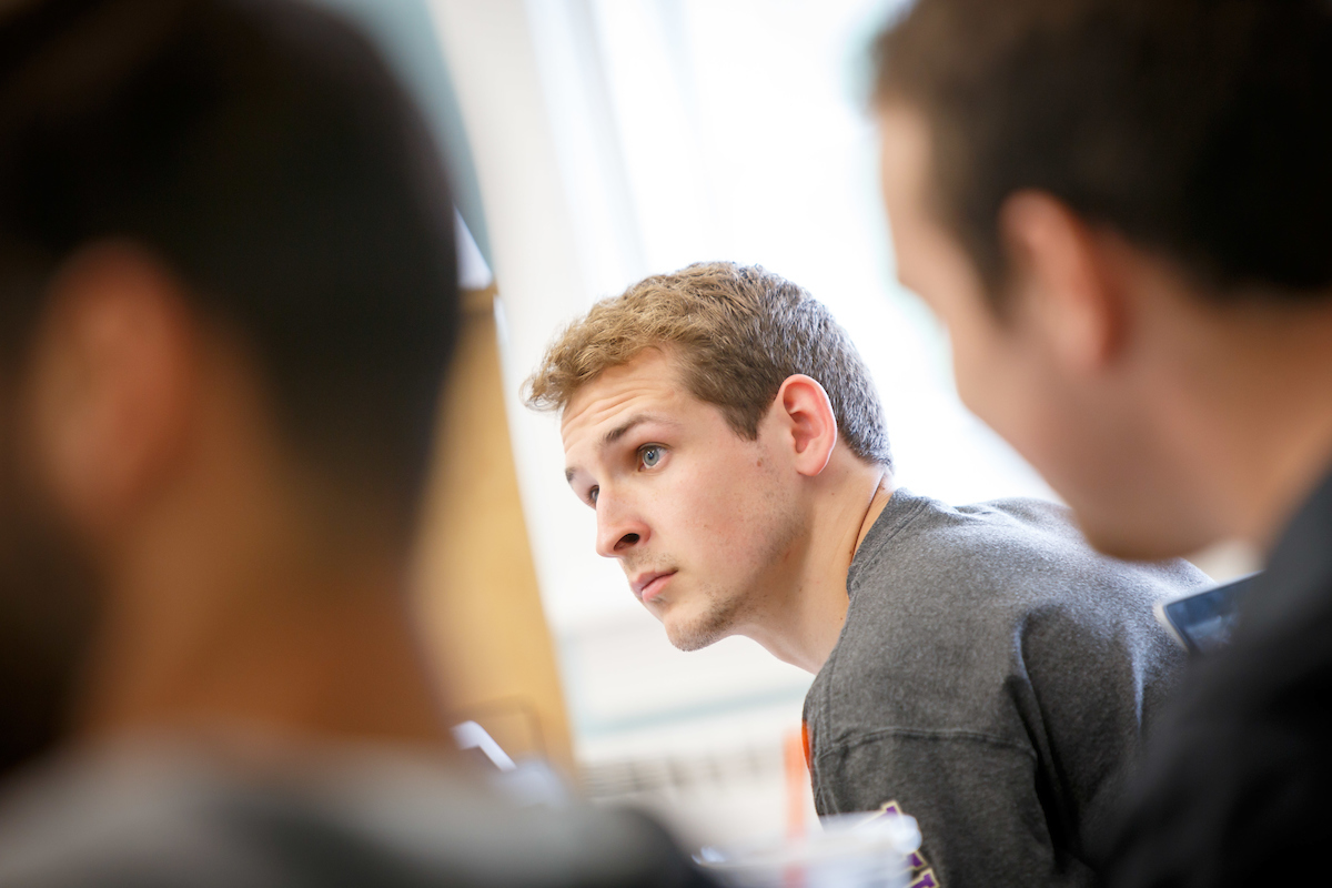 man in gray saint michaels leaning forward in chair