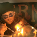 person poking at a small fire