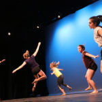 women performing ballet on stage