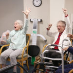 senior citizens cheering in a nursing home