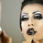 person painting their lips black