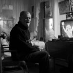man sitting in an old-style room