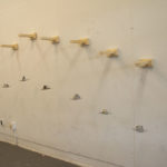 art sculpture hanging on a wall