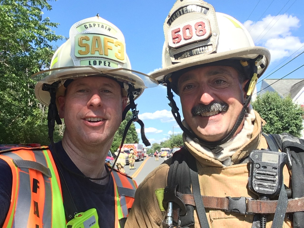 A photo of Matt Lopez and another firefighter in uniform.