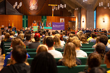 Kelechi Onuoha '23 inspires and fires up the new Class of 2026 Friday evening in the chapel.