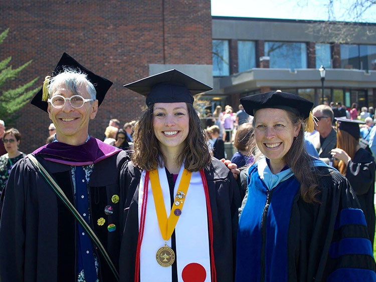 A photo of Victoria Smith with her professors at her graduation.