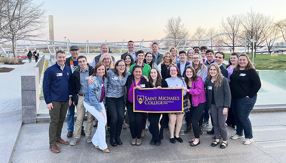 Alumni and the visitors together at a networking social Thursday night, which was Purple & Gold Day.