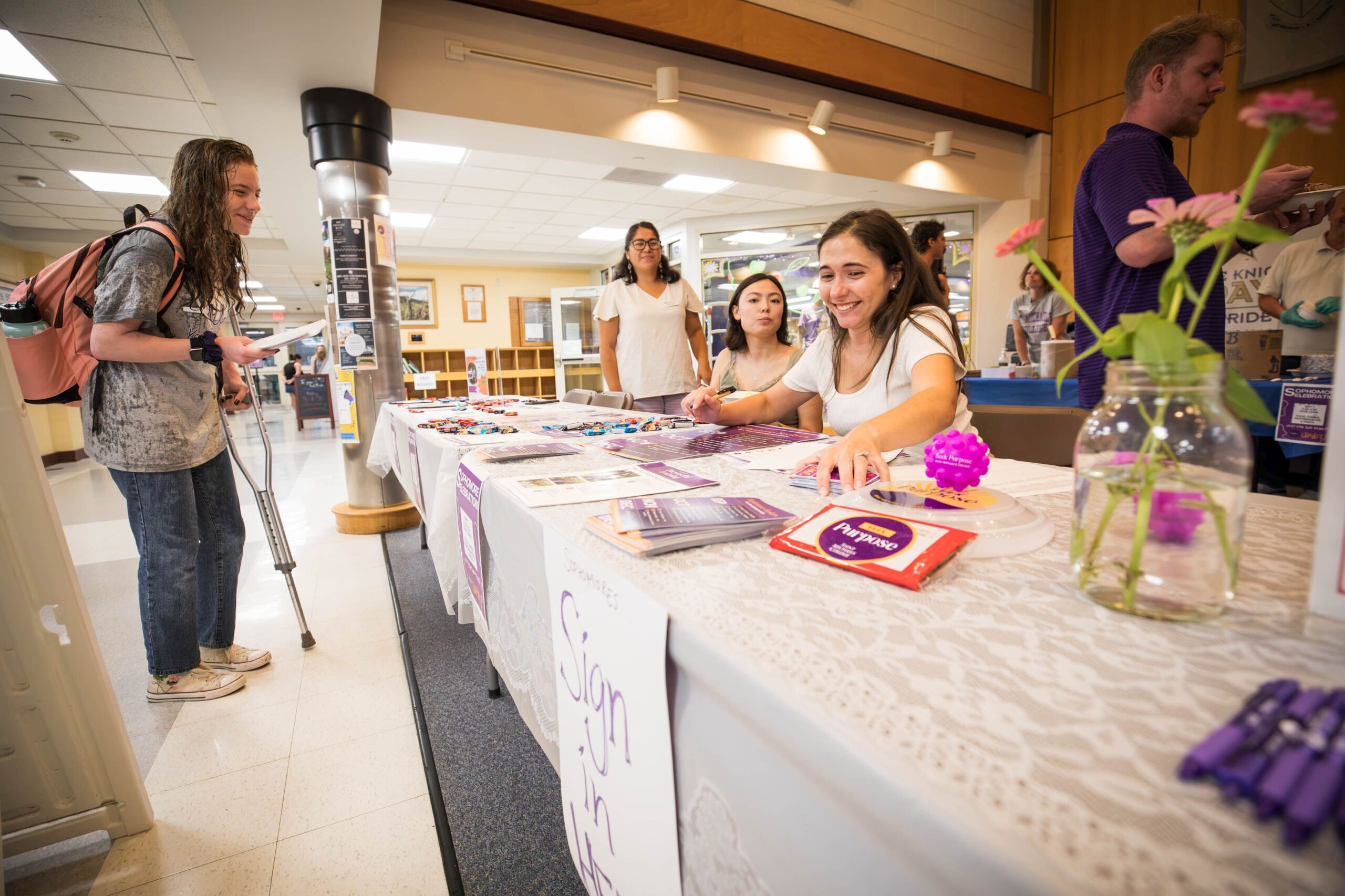 students talking together over an informational table