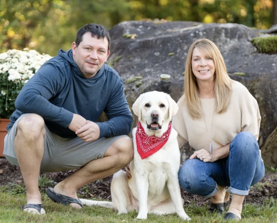 Chris Line and Saint Michael's College alumna Karen Wisehart pose with their Labrador Retriever, inspiration for name of the business, Vermont Cider Lab.