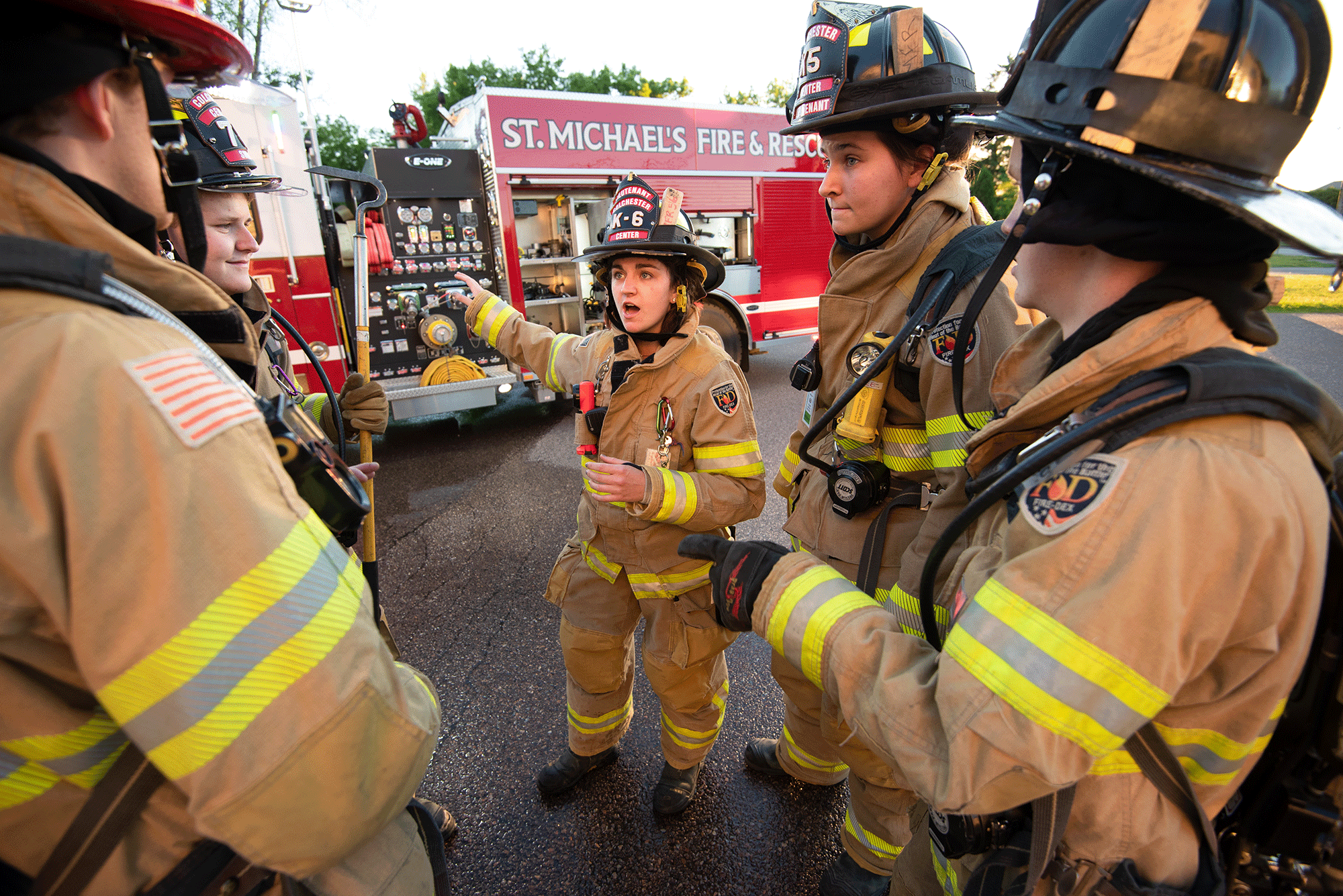 Members of the Saint Michael's College Fire and Rescue department plan out strategy during a simulation on campus.