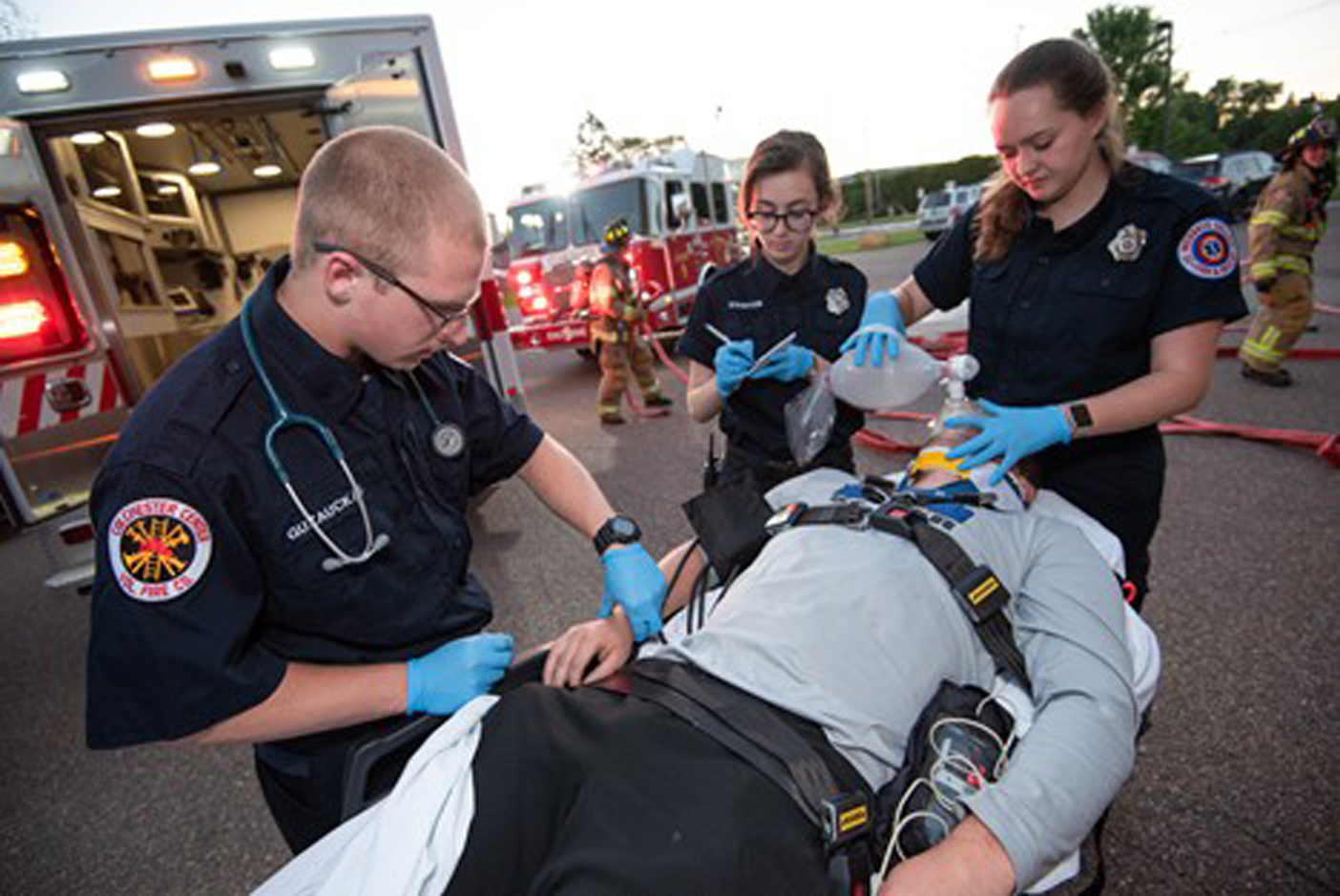three ems personnel tending to a person on a stretcher